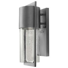 an outdoor wall light with water droplets on the glass and metal frame, is shown against a white background