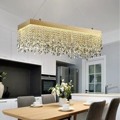 a chandelier hanging over a dining room table