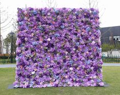 a large purple flowered wall is in the grass