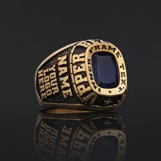 a close up of a ring with a blue stone in it on a black background