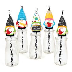 four glass bottles with gnome hats on them