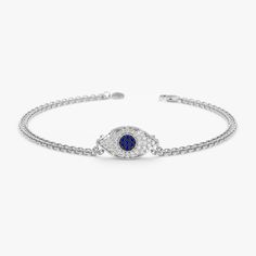 Elsie Embrace protection and September style with our Sapphire & Diamond Evil Eye Bracelet. This captivating bracelet combines the rich blue hues of a genuine sapphire with the sparkling brilliance of white diamonds, all set within a protective evil eye symbol. - Handmade- Solid Gold- Natural Diamond and Blue Sapphire- G Color, SI Quality Diamonds- Total Diamond Carat Weight: 0.18 ctw- Total Sapphire Carat Weight: 0.05 ctw- Dimensions of Evil Eye: 7.5 x 13.5 mm All pieces come beautifully boxed Fine Jewelry Sapphire Bracelets, Gift Sapphire Diamond Bracelet, Elegant Blue Evil Eye Bracelet, White Gold Sapphire Bracelet In Fine Jewelry Style, Sapphire Bracelets With Diamond Accents, Sapphire Tennis Bracelet With Diamond Accents As Gift, Sapphire Diamond Tennis Bracelet Gift, White Gold Sapphire Bracelet As Gift, Elegant Silver Bracelets With Diamond Eyes