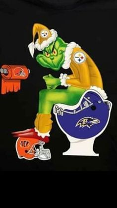 an image of a cat sitting on top of a toilet with football helmets around it