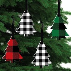 four christmas trees are hanging from a tree