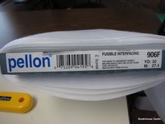 the label for pellon is on top of a plastic container with a yellow object next to it