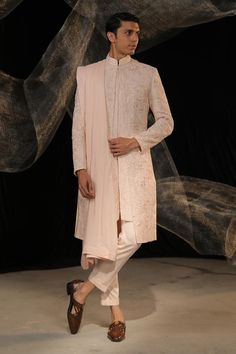 Blush pink sherwani with all over embroidery using resham and beaded work . Paired with an inner kurta and pant. Comes along with a dupatta.
Components: 4
Pattern: Embroidery
Type Of Work: Resham, Beads
Neckline: Stand Collar
Sleeve Type: Full Sleeves
Fabric: Crepe: Sherwani, Cotton Silk: Kurta and Pant
Color: Pink
Other Details: 
Embroidery on dupatta
Occasion: Destination Wedding,Groom - Aza Fashions Semi-stitched Pink Sherwani With Intricate Embroidery, Pink Semi-stitched Sherwani With Intricate Embroidery, Pink Sherwani With Intricate Embroidery For Reception, Pink Bollywood Sherwani With Intricate Embroidery, Elegant Pink Sherwani With Resham Embroidery, Elegant Pink Sherwani With Intricate Embroidery, Pink Unstitched Suit With Naqshi For Wedding, Pink Unstitched Naqshi Suit For Wedding, Pink Naqshi Unstitched Suit For Wedding