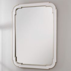 a mirror mounted to the side of a wall