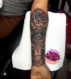 a person with a rose tattoo on their arm