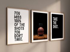 three black and white posters on the wall above a basketball ball with a basket in it