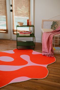 an orange and pink rug is on the floor