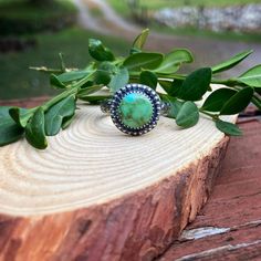 A round shaped green Sonoran Gold Turquoise stone is wrapped in fine silver and surrounded by silver beading.  The head of this ring measures a bit over 1/2" round. Please see photos for size reference.  The ring band is made of sterling silver and has a flower and leafy tendril pattern on it.  Size: 10 * This ring cannot be resized  All photos are taken in natural outdoor lighting conditions. Please contact me with questions or additional photos Adjustable Green Turquoise Southwestern Ring, Southwestern Sterling Silver Turquoise Ring, Artisan Green Turquoise Sterling Silver Ring, Nickel-free Southwestern Style Rings, Southwestern Style Turquoise Ring Stamped 925, Southwestern Style Stamped 925 Turquoise Ring, Nickel-free Southwestern Round Turquoise Ring, Nickel-free Round Southwestern Turquoise Ring, Nickel Free Round Southwestern Turquoise Ring