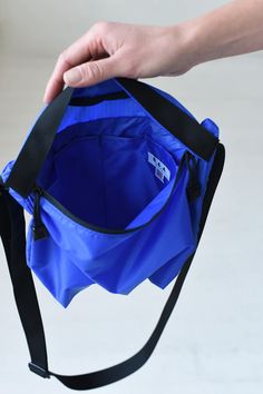 Super light weight, durable and water resistant nylon crossbody bag. 1.9oz ripstop nylon (100% nylon) 11.5" (W) 8" (H) 3.5" (D) Nylon webbing strap Zipper closure, two interior pockets, one exterior zipper pocket Unlined interior Made in USA Waterproof Blue Nylon Bags, Blue Nylon Bag With Functional Pockets, Waterproof Nylon Shoulder Bag For Everyday Use, Blue Nylon Hiking Bag, Blue Outdoor Bags With Ykk Zipper, Waterproof Nylon Crossbody Shoulder Bag, Blue Nylon Shoulder Bag For Outdoor, Nylon Hiking Shoulder Bag With Zipper Pocket, Nylon Shoulder Bag With Zipper Pocket For Hiking