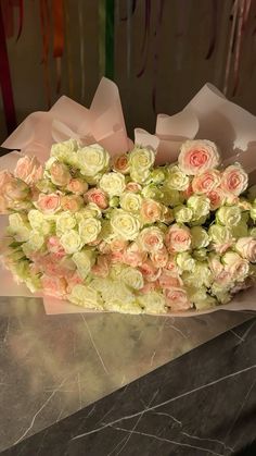 a bouquet of flowers sitting on top of a table next to a marble countertop