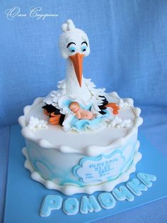 a baby shower cake with a stork on top