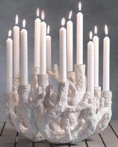 a group of white candles sitting on top of a table