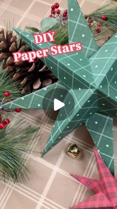 an origami star and pine cones on a table with the words diy paper stars