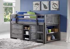 a child's loft bed with drawers underneath it in a blue walled nursery room