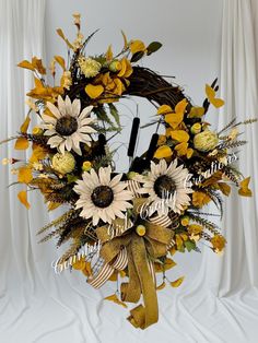 a wreath with sunflowers and other flowers on it