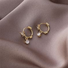 Dressing to impress is a breeze when you don these 18k gold-plated beauties that boast sparkling cubic zirconia accents. 0.87" L 18k gold-plated copper / cubic zirconia Gold Diamond Earrings As A Gift, Gold Diamond Earrings With Sparkling Stones For Gift, Gold Cubic Zirconia Earrings For Anniversary, Gold Dainty Hoop Earrings With Sparkling Stones, Dainty Gold Hoop Earrings With Sparkling Stones, Elegant Gold Crystal Earrings With Prong Setting, Gold Cubic Zirconia Diamond Earrings For Anniversary, Tarnish Resistant Diamond White Cubic Zirconia Earrings, Gold Cubic Zirconia Earrings As Gift