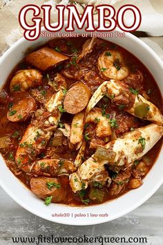 a bowl of gumbo stew with shrimp, potatoes and carrots on the side