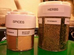 two jars filled with spices sitting on top of a green counter