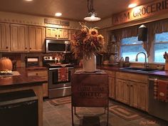 a kitchen filled with lots of wooden cabinets and counter top space next to a window