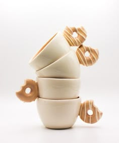 a stack of white and brown cups sitting on top of each other