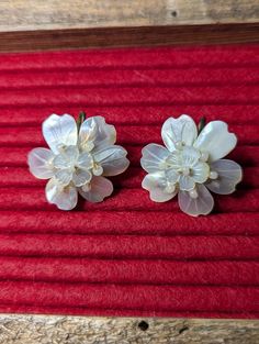 Embrace timeless elegance with these Italian Mother-of-Pearl Flower Screwback Earrings. Featuring exquisite engraved and beaded details, these vintage-inspired beauties reflect authentic Italian craftsmanship. Perfect for special occasions or everyday luxury, add a touch of classic sophistication to your collection. Stamped "Made in Italy" Approx 1.5" across Vintage disclaimer: Many of the items we sell are vintage and have been previously owned. Some may show signs of wear consistent with their age. That wear adds to the piece's unique history, charm, and character, and we do our best to show any wear in detailed photos. Of course, if you have questions, please ask and we will respond promptly! Vintage Inspired Jewelry, Italian Jewelry, Pearl Flower, Everyday Luxuries, Stamp Making, Wedding Jewelry Earrings, Screw Back Earrings, Wedding Earrings, Mother Of Pearl