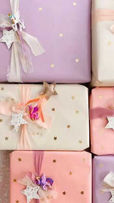 four wrapped gift boxes with bows and stars on them