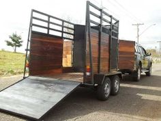 a truck with wooden doors is parked on the side of the road