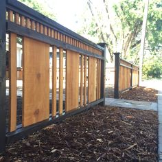 a wooden fence with slats on the sides and wood shavings all around it