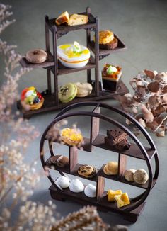 an assortment of pastries are arranged on three tiers