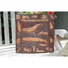 a carved wooden box sitting on top of a bench