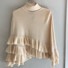 This Ivory Knit Ponch Is A Must To Elevate Any Outfit. Super Soft And With Details In End Fringe At Bottom Which Is Also Asymmetrical. Never Used Or Worn With Tags. Beige Poncho For Spring Layering, Beige Poncho For Layering, One Size Beige Poncho For Layering, Spring Beige Knit Poncho, Beige Knit Poncho For Spring, Chic Beige Poncho For Spring, One-size Cream Sweater For Layering, One Size Cream Sweater For Layering, Cream Knitted Poncho For Fall