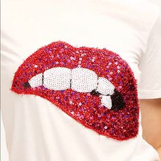 This Sparkle Lips Tee Is Perfect To Add A Fun Piece To Your Wardrobe. White Short Sleeve Trendy Red T-shirt For Party, White Cotton Party T-shirt, Red Short Sleeve T-shirt For Party, Red Sequin Tops For Spring, Red Casual T-shirt For Party, Casual Red T-shirt For Party, Red Casual Party T-shirt, Casual Red Sequined Tops, White Crew Neck Top For Party