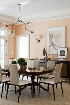 a dining room table and chairs with chandelier in the middle of the room