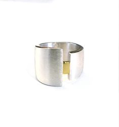 This fabulous wide minimalist ring is hand made in Sterling Silver and 18ct Yellow Gold. The widest side is 19mm from top to bottom and the narrower side is approx 11mm from top to bottom, tapering down to approximately 12mm at the back of the ring. The rectangle in the centre is shiny. The silver band has a satin or Florentine finish, and the edges of the ring are shiny. Made to last, this solid ring can be worn day-in, day-out and will look great with gold and silver jewellery, it's great to m Ring Bands, Large Statement Earrings, Hanging Necklaces, Handmade Jewelry Earrings, Wide Rings, Ring Minimalist, Minimalist Ring, Minimalist Rings, Handmade Sterling Silver