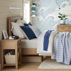 a bed room with a neatly made bed next to a night stand and nightstands