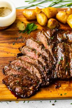 steak and potatoes on a wooden cutting board