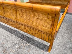 a bed frame made out of bamboo sitting on the ground