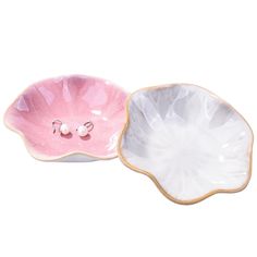 two pink and white dishes sitting next to each other