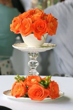 two tiered plates with orange flowers on them