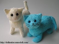 two small stuffed animals one is blue and the other is white with black spots on it's eyes