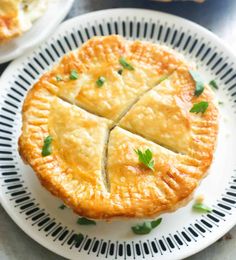 two white plates topped with pies on top of a table