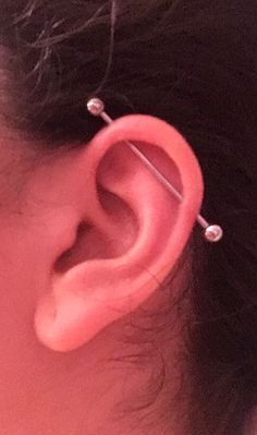 an ear with two piercings attached to it