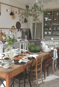 a dining room table with plates and bowls on it