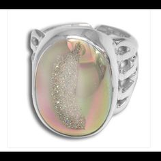 A 15x20mm Opalized Window Druzy Oval Is Bezel Set In 925 Sterling Silver In This Beautiful Ring! Opalized Druzy Shimmers And Shines With Many Colors Like Pink, Aqua And Yellow! This Stone Is 15x20mm And The Face Of The Ring Is Nearly 1". The Back Of The 1/4" Wide Band Has Been Left Open To Allow Gentle Re-Sizing Up To One Ring Size Larger. Width: 0.625 In Length: 1 In Height: 0.25 In Unique Silver Crystal Ring For Formal Occasion, Modern Silver Rings With Cabochon, Elegant Iridescent Crystal Ring Adjustable, Elegant Iridescent Adjustable Crystal Ring, Nickel-free Silver Crystal Ring For Anniversary, Silver Crystal Promise Ring With Polished Finish, Silver Crystal Ring With Polished Finish For Gift, Unique Silver Oval Crystal Ring, Sparkling Silver Crystal Ring Gift