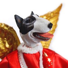 a close up of a toy dog wearing a red coat and gold foiled decorations