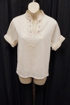 Vintage 1940's-50s Ivory Nylon Gorgeous Delicate Romantic Textured Blouse Top Shirt Blouson w Lace and Embroidered Flower Details.  Top is in Amazing vintage condition - See pics for the tiny detailing on the lace and embroidered flowers! Measurements: shoulder to shoulder 15 in, chest 36 in, waist 34, back of neck to waist front length 22 1/2, length in back 24, sleeves shoulder to cuff 7 1/2, sleeves pit to cuff 3 1/2, side vents 4 in. Please see our other listings for slips to wear underneath Feminine Cream Blouse With Floral Embroidery, Fitted Cream Blouse With Floral Embroidery, Vintage White Blouse For Spring, Cream Cottagecore Blouse For Spring, Vintage White Blouse For Summer, Vintage Beige Blouse For Spring, Beige Blouse With Floral Embroidery For Daywear, Cream Cottagecore Top For Spring, Vintage Floral Embroidered Blouse For Spring