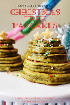 christmas tree pancakes on a plate with sprinkles in the foreground and text overlay that reads, merry christmas tree pancakes